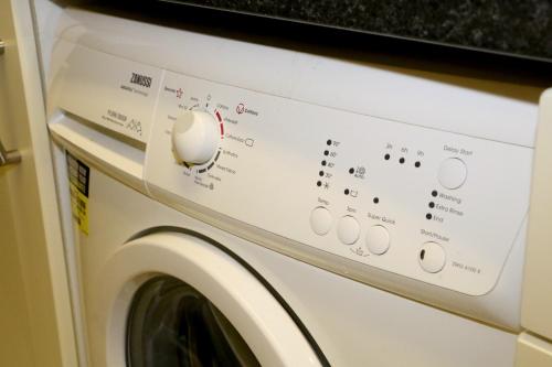 a white washer and dryer with a washing machine at Emy Lake Apartment - near Castle Leslie, Glaslough in Monaghan
