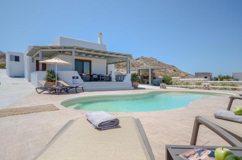 a villa with a swimming pool and a house at Naxos Secret Paradise Villa in Galini