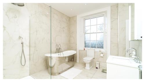 a bathroom with a sink and a toilet and a shower at A Luxurious Masterpiece Steps from Stirling in Stirling