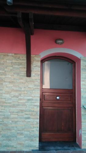 a large wooden door on the side of a building at LA PETITE MAISON in Fucecchio