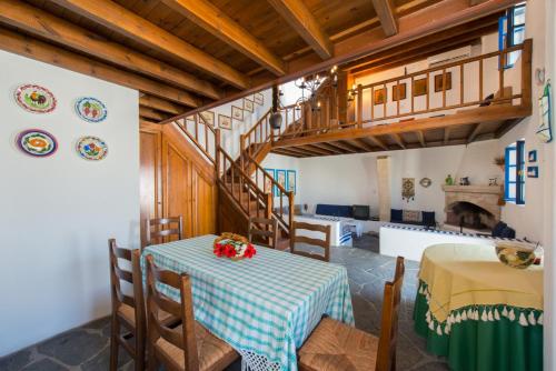 comedor con mesa y escalera en Litsa Holiday Home, en Kalathos