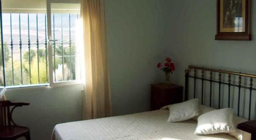 Uma cama ou camas num quarto em Casa Cantarrana