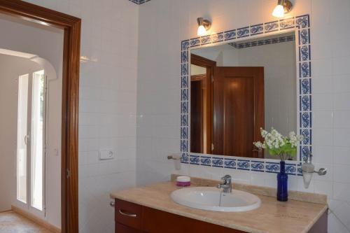a bathroom with a sink and a mirror at Villa Coqueta in Sant Josep