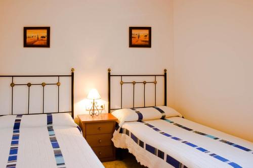 two beds sitting next to each other in a room at Villa Coqueta in Sant Josep