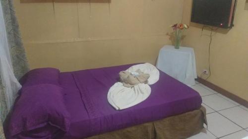 En eller flere senge i et værelse på Hotel Coto