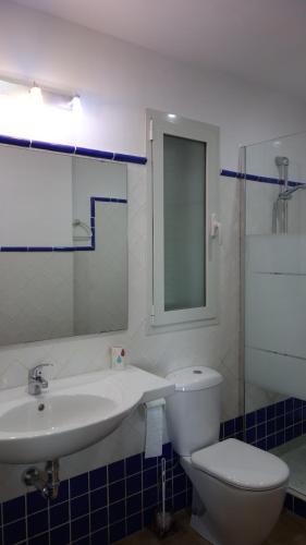 a bathroom with a sink and a toilet and a mirror at Marino apartment in Almuñécar