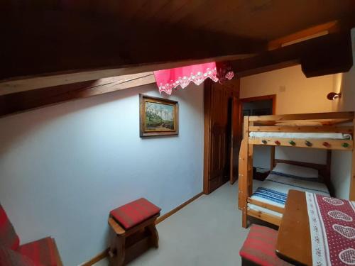 a room with two bunk beds in a house at Mansarda in chalet a Cortina in Cortina dʼAmpezzo
