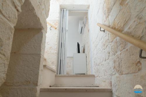 an alley with a window in a stone wall at Casa Filomena in Ostuni