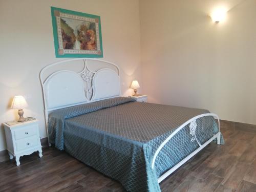 a bedroom with a bed and two night stands at Agriturismo Colleverde Capalbio in Capalbio
