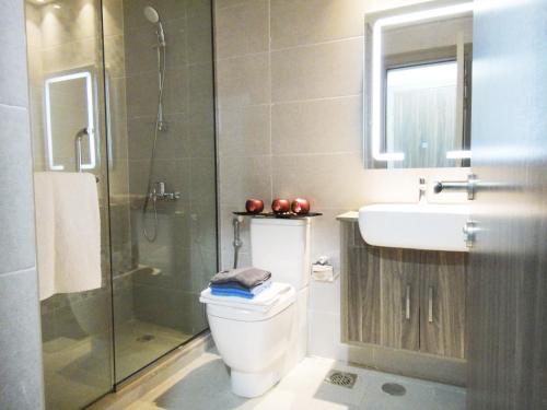 a bathroom with a toilet and a sink and a shower at Warsan Star Residence - Home Stay in Dubai