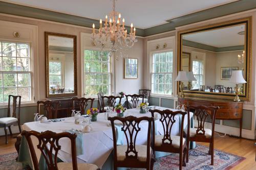 uma sala de jantar com uma mesa e um piano em The Morehead Inn em Charlotte