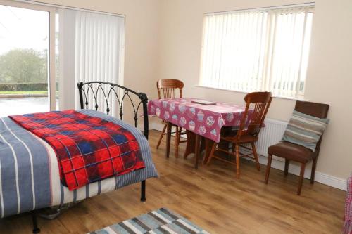 a bedroom with a table and chairs and a dining room at Emy Lake Studio in Monaghan
