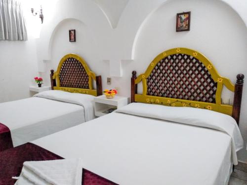 Tempat tidur dalam kamar di Hotel Esmeralda