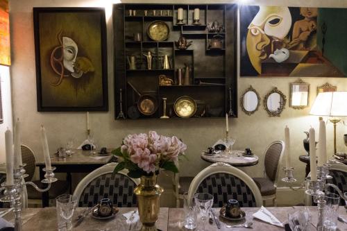 a dining room with a table with a vase of flowers at Casa Falleri Boutique Hotel in Lima