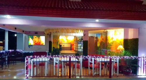 a restaurant with red chairs and a table with lights at Hotel Esmeralda in Poza Rica de Hidalgo