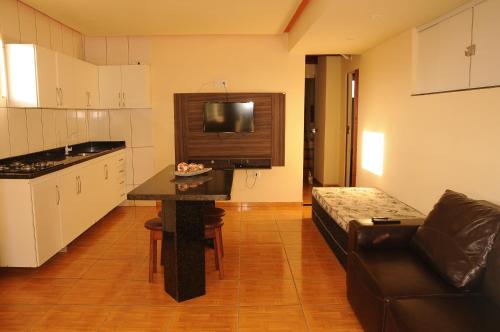 a kitchen with a table and a couch in a room at Mica Flats in Prado