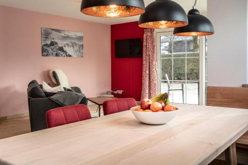 a dining room with a table with a bowl of fruit on it at Ferienwohnungen "Zur Wally" in Garmisch-Partenkirchen