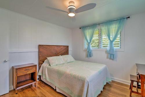 a bedroom with a bed and a ceiling fan at Charming Historic Hilo House Minutes to Beach! in Hilo