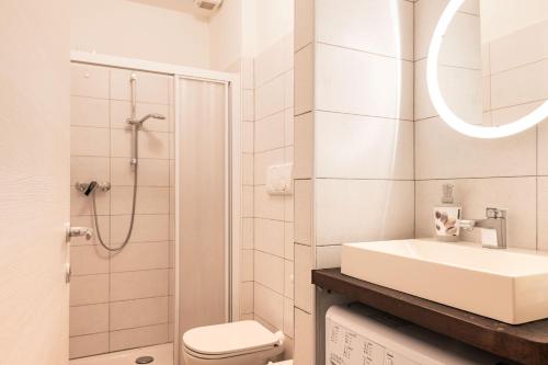 a bathroom with a sink and a toilet and a shower at ANDREA Venice FLAT 1st Floor in Venice