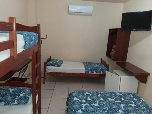 En eller flere senge i et værelse på Pousada Paraiso