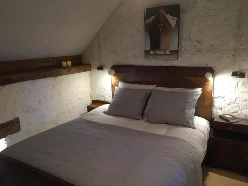 a bedroom with a large bed with two pillows at Les Bouaux, Lavena in Cussy-en-Morvan