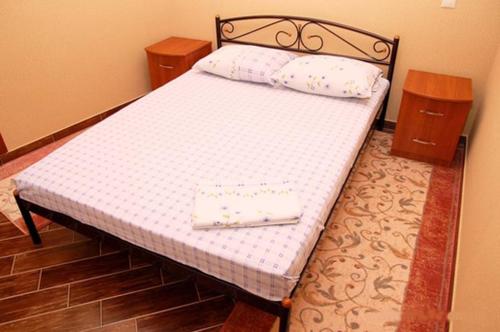ein Bett mit zwei Kissen auf einem Zimmer in der Unterkunft Sofiivs'ka Street, 1,, in Kiew