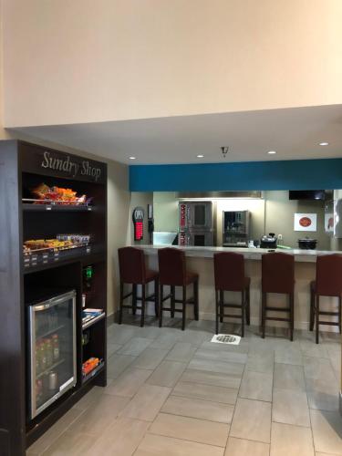 a kitchen with a microwave, refrigerator, sink, and dishwasher at Greenstay Inn & Suites Court View in Springfield