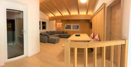 a living room with a table and a couch at Jochberg Hoamatl in Jochberg