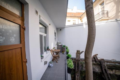 a balcony with a door and a table and chairs at Apartman Sv. Urban in Bratislava