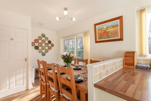 a kitchen and dining room with a table and chairs at Cedar Place in Southwell in Southwell