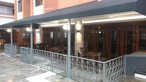 a restaurant with tables and chairs on a balcony at Country Plaza in Guadalajara
