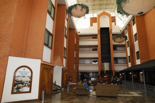 a lobby with people sitting in chairs in a building at Country Plaza in Guadalajara