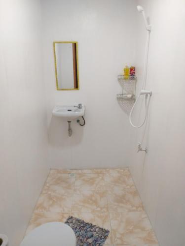 a bathroom with a toilet and a sink at Casa de Corazon in Kandabong