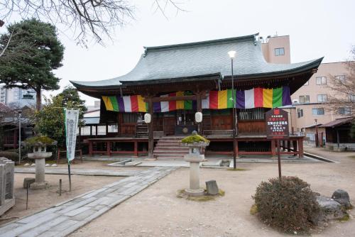 a building with colorful flags on the front of it at Hotel Hana in Takayama