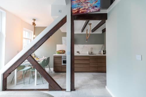 a kitchen and dining room with a loft at New Scheveningen Beach Central The Hague Family 180D Modern top floor Apartment in Scheveningen