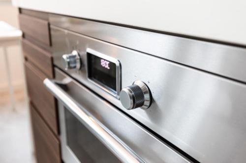 a close up of a stainless steel kitchen oven at New Scheveningen Beach Central The Hague Family 180D Modern top floor Apartment in Scheveningen
