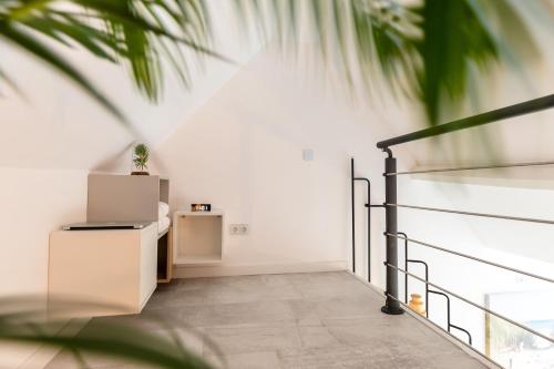 a room with white walls and a staircase at New Scheveningen Beach Central The Hague Family 180D Modern top floor Apartment in Scheveningen
