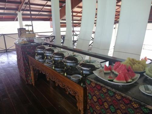 a buffet with a plate of fruit on a table at Sea Star Resort Semporna in Semporna