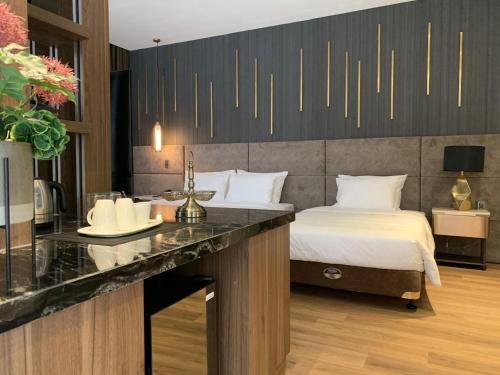 a hotel room with a bed and a counter with a table at Hadiva Boutique Hotel in Da Nang