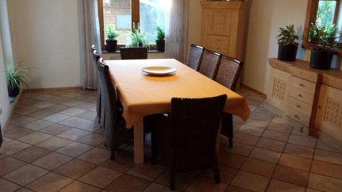 a dining room with a wooden table and chairs at Ferienhaus Schwörer in Rheinhausen