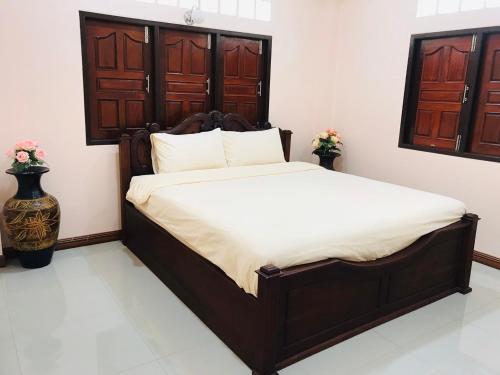 a bedroom with a large bed in a room at Suan Luang Garden View in Nong Khai