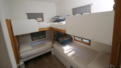a room with three bunk beds in a room at Beauty Point Tourist Park in Beauty Point