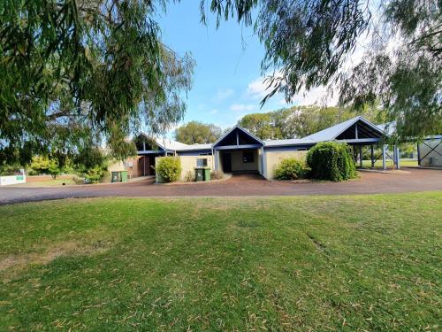 a group of buildings with a grass yard at Busselton Holiday Units in Busselton