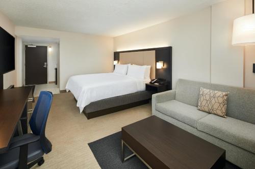 a hotel room with a bed and a couch at Holiday Inn Express Richmond - Midtown by IHG in Richmond