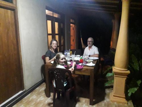 a group of people sitting at a table at Shan Mango Homestay in Sigiriya