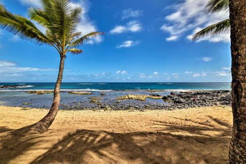 two palm trees on a beach with the ocean at Condo with Lanai at Beginning of Road to Hana! in Paia