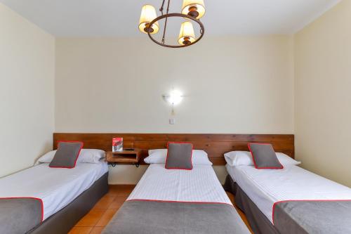 Ένα ή περισσότερα κρεβάτια σε δωμάτιο στο Hotel Mavi