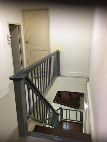 a stairway with a white door and a stair case at Baan Suan Resort2345 in Ban Nong Waeng