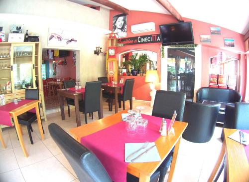 a dining room with tables and chairs in a restaurant at Atoll Hotel restaurant in Fréjus
