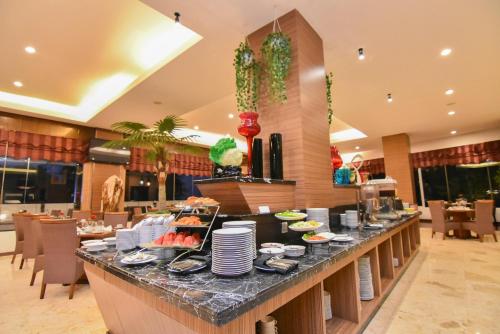 a buffet in a restaurant with food on a counter at Grand Rocky Hotel Bukittinggi in Bukittinggi
